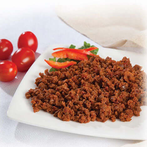 Protein entrees featuring seasoned plant-based crumbles served with fresh vegetables and cherry tomatoes.